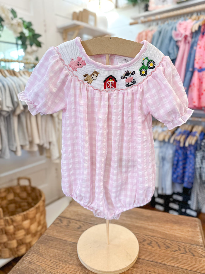 baby size pink checkered bubble romper with farm them along collar line 