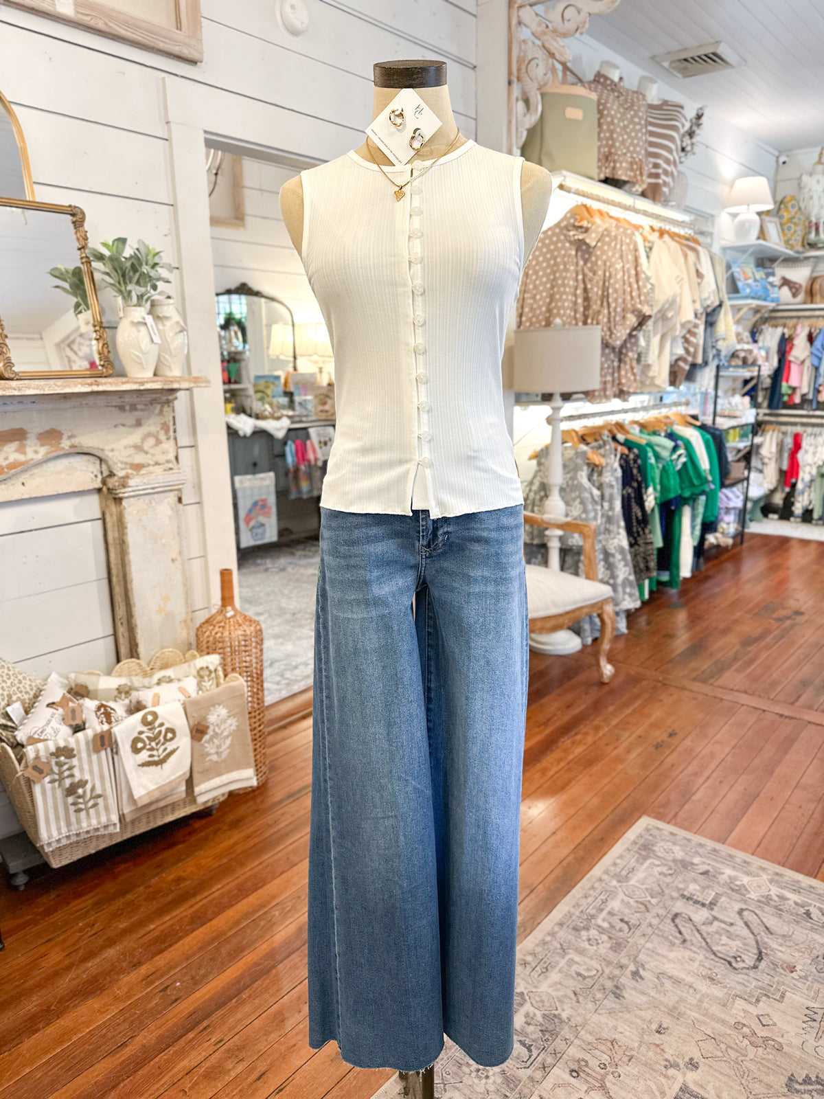 Mannequin wearing a white shirt and blue jeans in a store setting