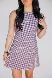 Woman wearing a checkered dress with text on a plain background