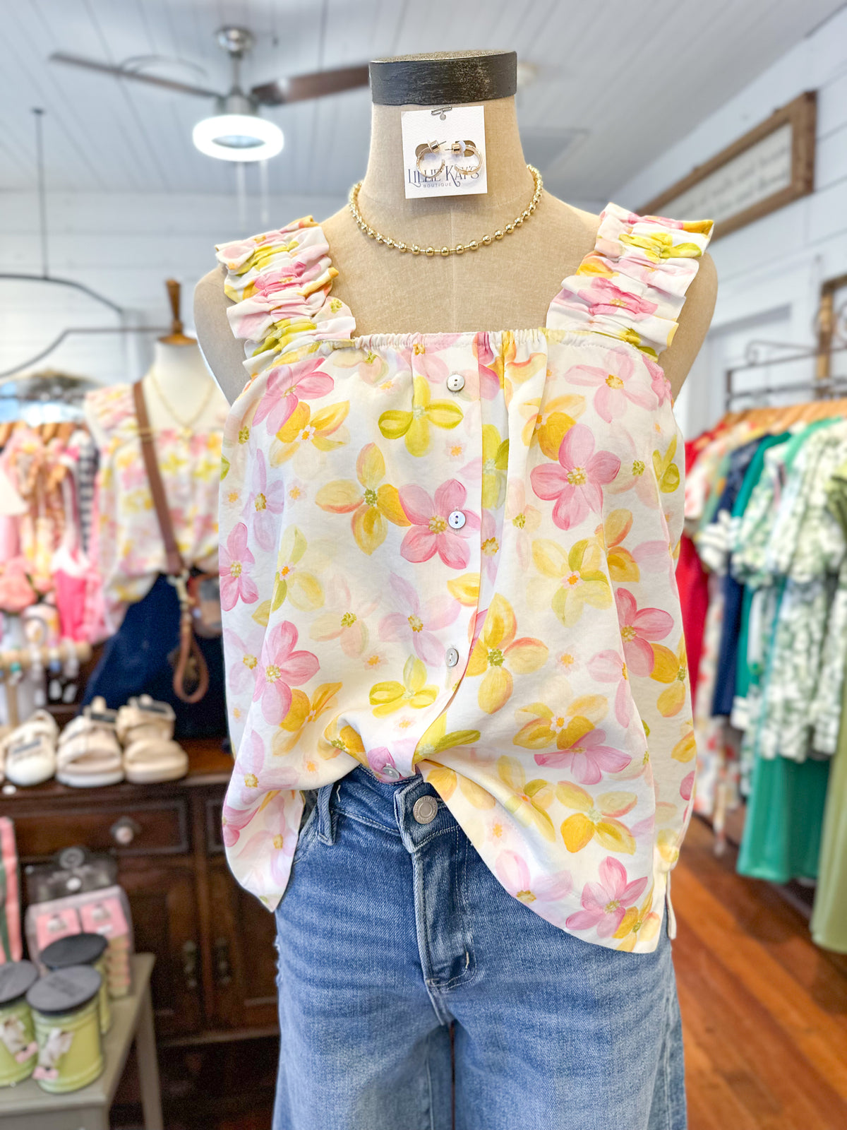 Floral top on a mannequin with jeans in a store setting