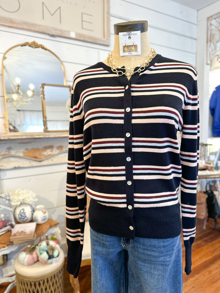 Striped cardigan on a mannequin with a store interior background