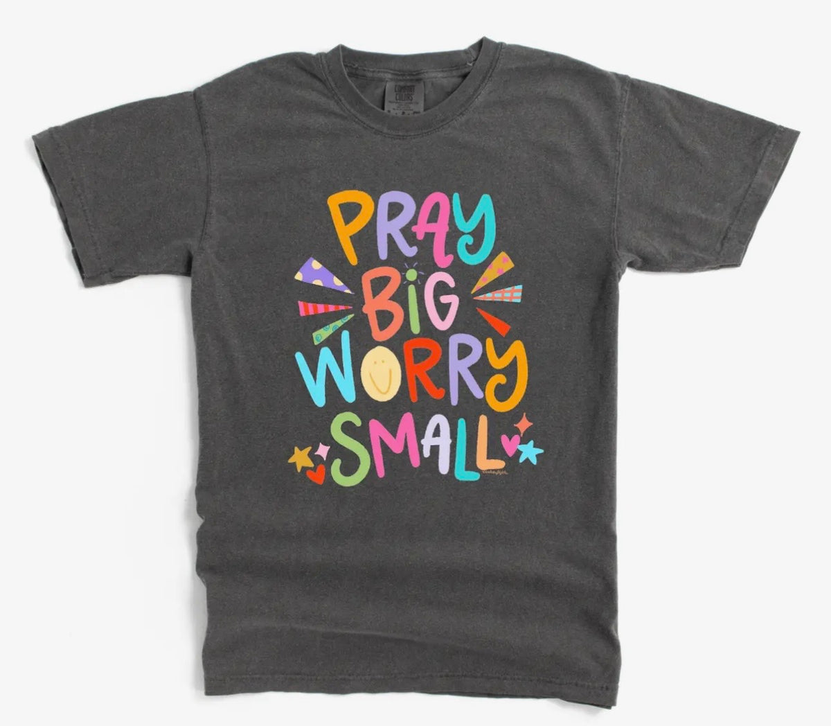 Dark gray t-shirt with colorful text 'Pray Big Worry Small' on a white background