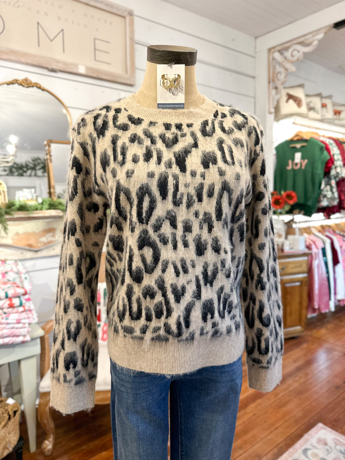 Leopard print sweater on a mannequin in a store setting