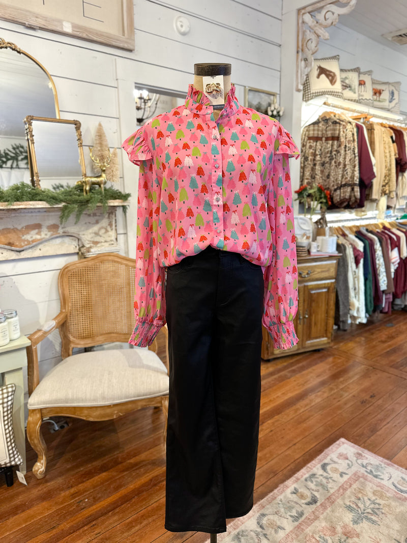 Pink floral blouse on a mannequin in a store setting with clothing racks and decor. christmas tree design 