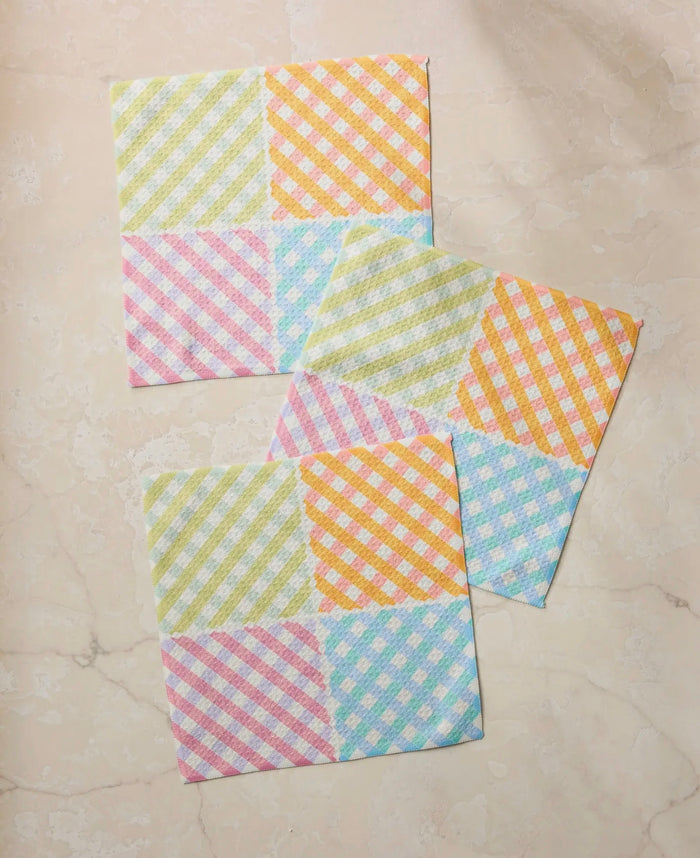 Set of colorful checkered cloths on a beige surface