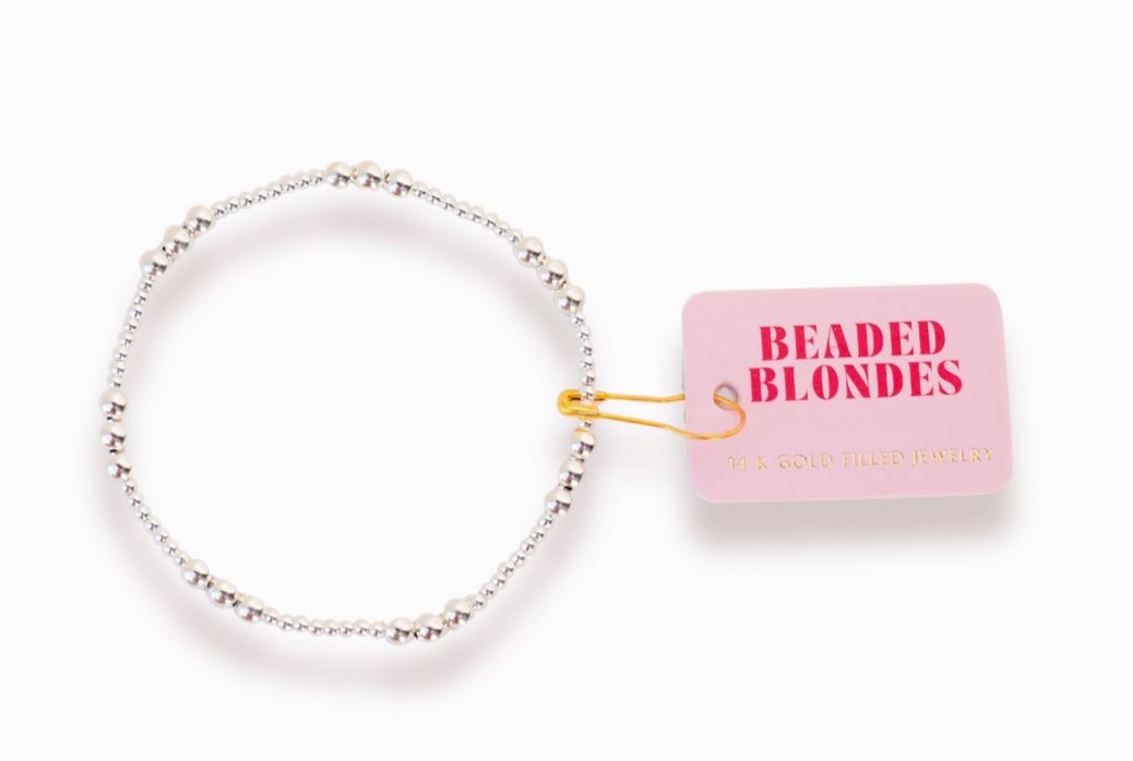 Beaded silver bracelet  pink packaging labeled 'Beaded Blondes' on a white background