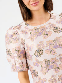 upclose pink brocade multi color dress with white background 
