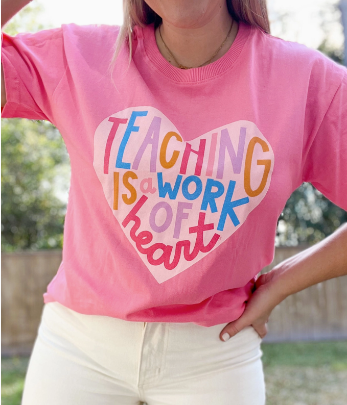 teaching is a work of heart tee on pink top 