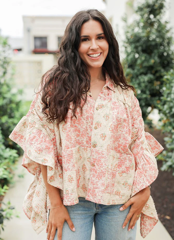 Woman wearing a floral blouse and jeans outdoors
layerz clothing florence poncho top 