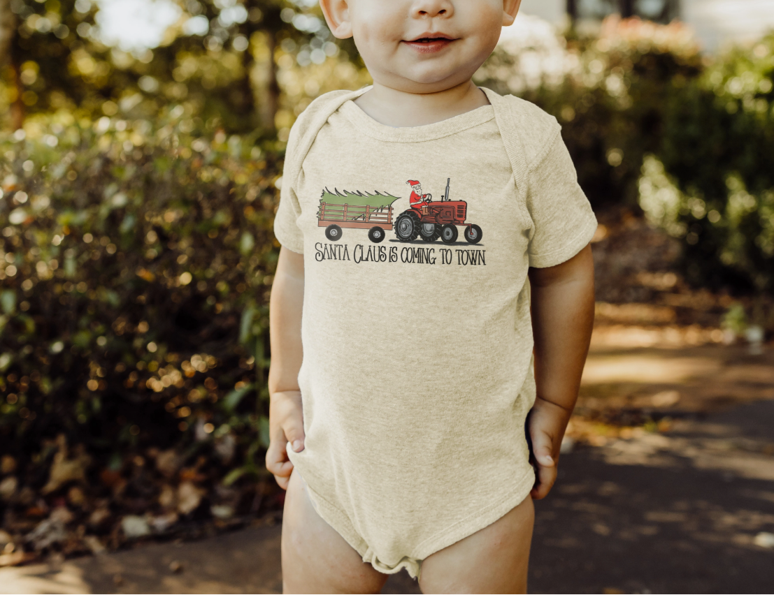 Child wearing a onesie with a Christmas design outdoors