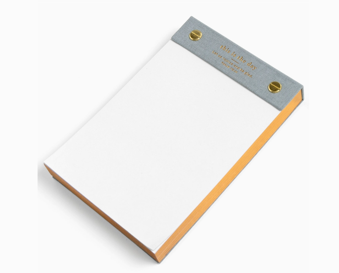 Notepad with a gray top corner and brown border on a white background