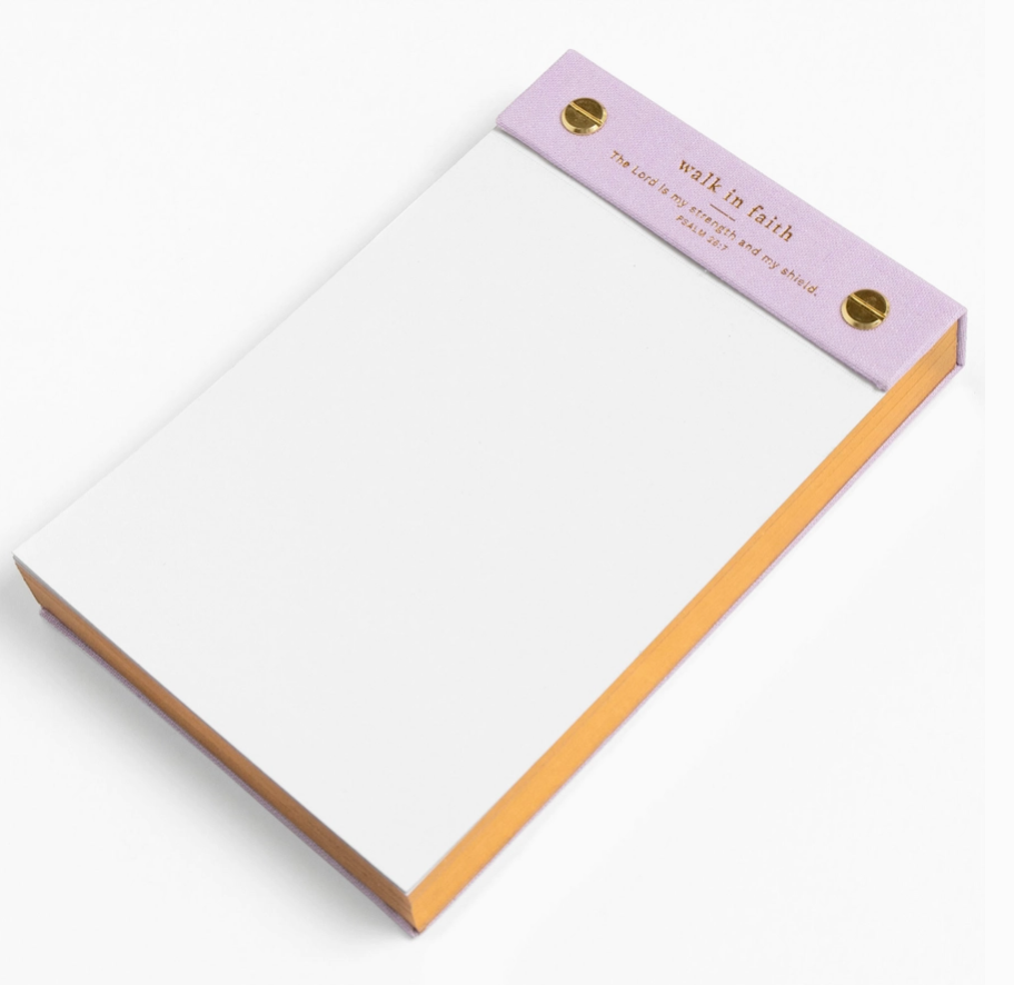 Notepad with a pink top edge and 'walk in faith' text on a white background