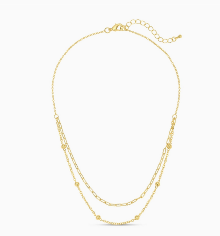 Gold multi layer necklace on a white background