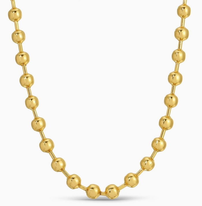 Gold beaded necklace on a white background