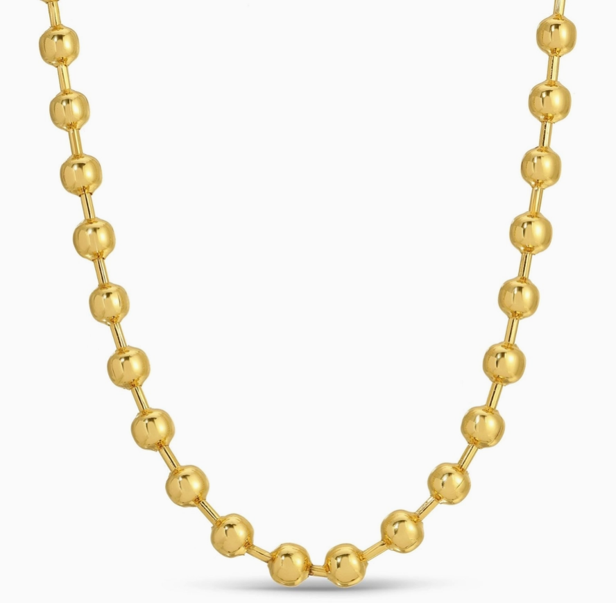 Gold beaded necklace on a white background