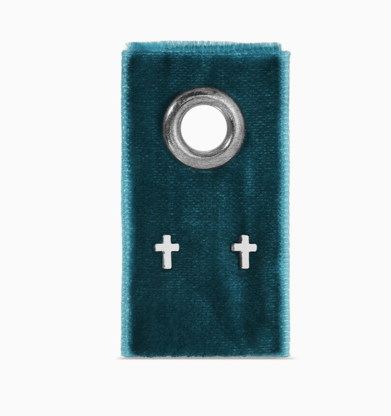 Teal velvet pouch with a metal ring and two silver cross-shaped earrings on a white background