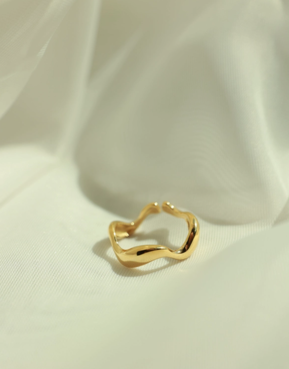 Gold ring on a light fabric background