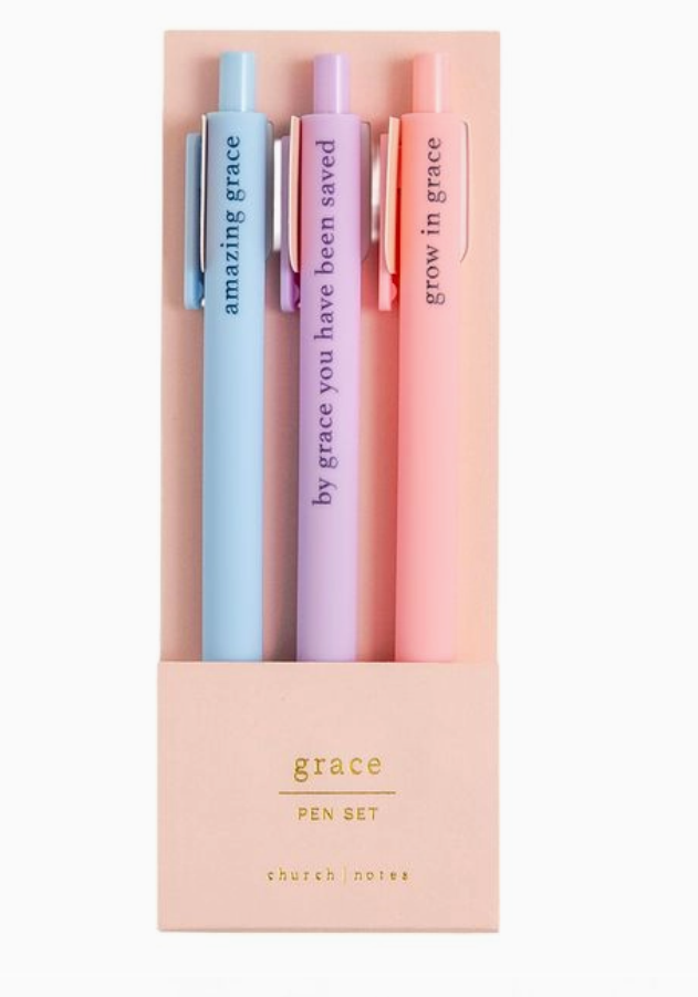 Set of three pens in pastel colors with motivational phrases in a pink packaging box.