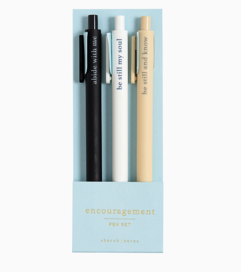 Set of three pens in a box with motivational phrases on a light blue background