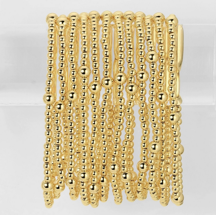 Gold beaded bracelet on a white background
