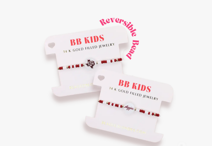 Two white card holders with red text and gold accents on a white background beaded blondes bracelet 