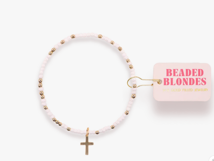 White beaded bracelet with gold beads and cross charm on a white background with 'Beaded Blondes' packaging.
