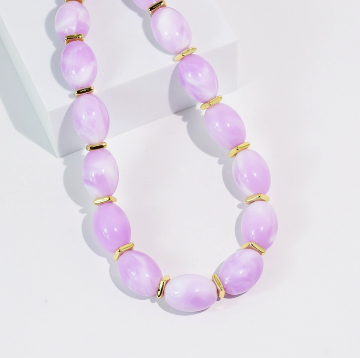 Necklace with lavender beads and gold accents on a white background