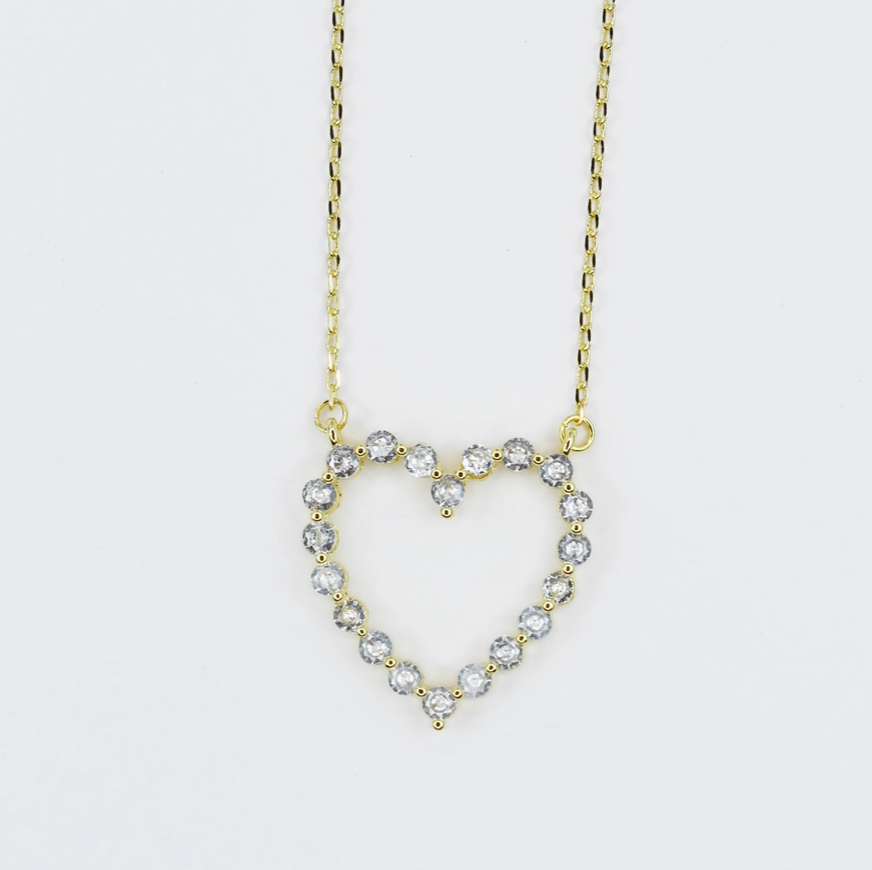 Heart-shaped diamond necklace on a light gray background