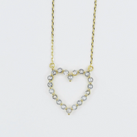 Heart-shaped diamond necklace on a light gray background