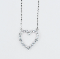 Heart-shaped necklace with clear stones on a light gray background