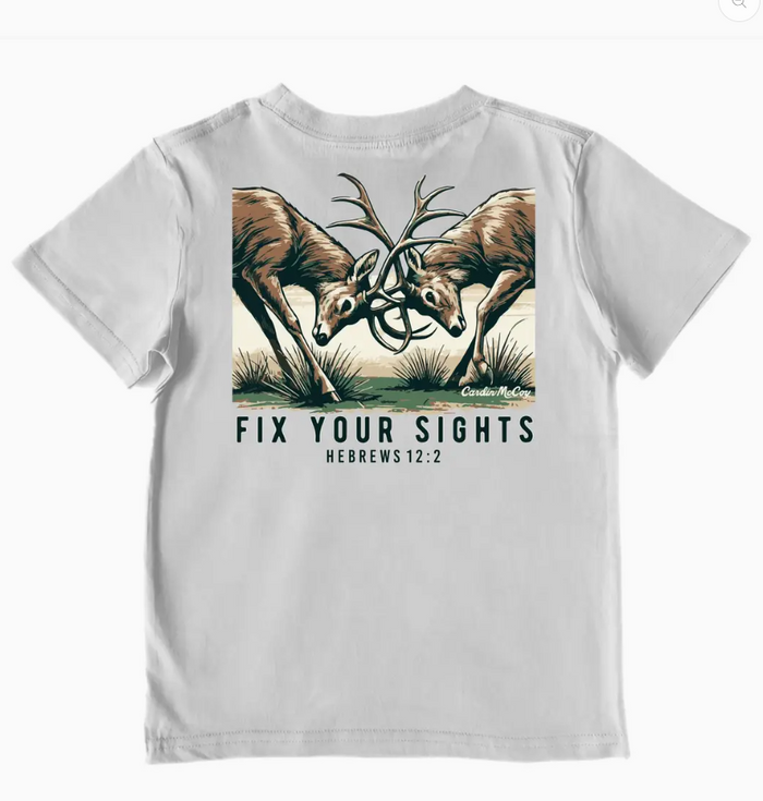 A light gray short-sleeve t-shirt featuring a graphic print of two antlered deer facing each other with the text 'FIX YOUR SIGHTS HEBREWS 12:2' printed below.