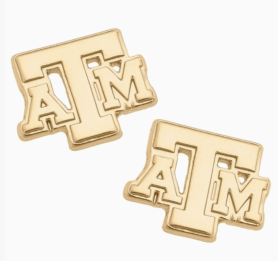 A pair of gold-toned stud earrings shaped like the Texas A&M 'ATM' logo, shown on a clean white background.