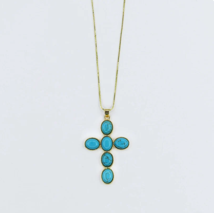 A gold cross pendant necklace featuring five oval turquoise-blue stones, suspended from a delicate gold chain against a plain white background.