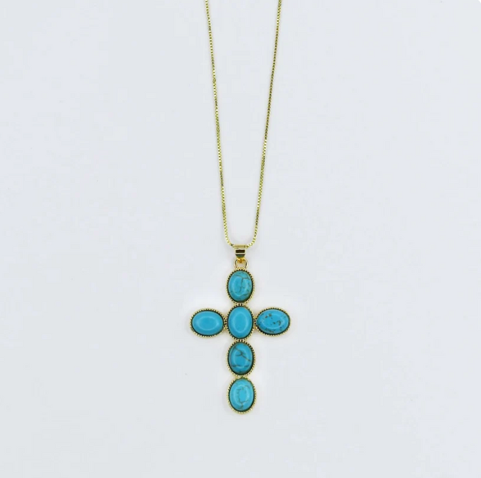 A gold cross pendant necklace featuring five oval turquoise-blue stones, suspended from a delicate gold chain against a plain white background.