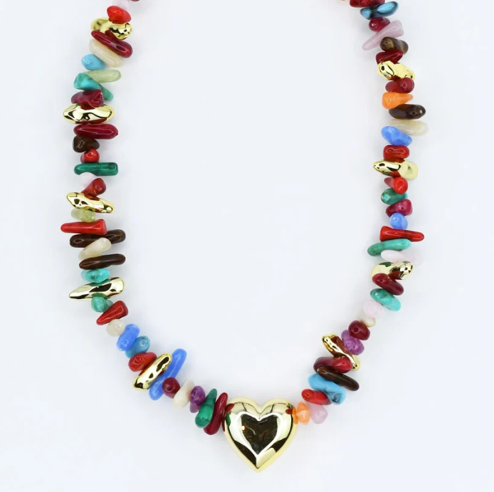A multicolor beaded necklace featuring a polished gold heart pendant at the center, set against a plain white background.