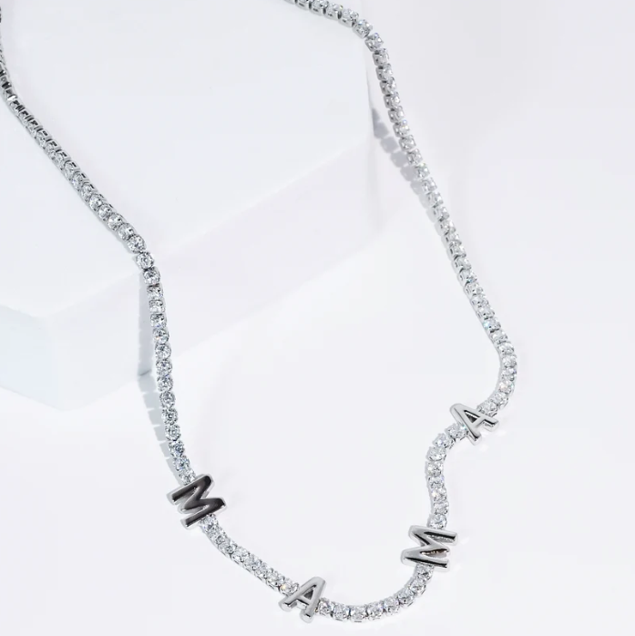A silver-toned initial necklace spelling 'MAM' with clear pavé stones, displayed on a clean white background.