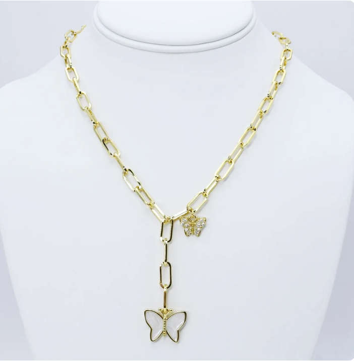 A gold-tone chain necklace displayed on a white mannequin bust. The necklace features a paperclip-style chain, a butterfly-shaped pendant with a small clear stone center, and a small butterfly charm near the clasp.