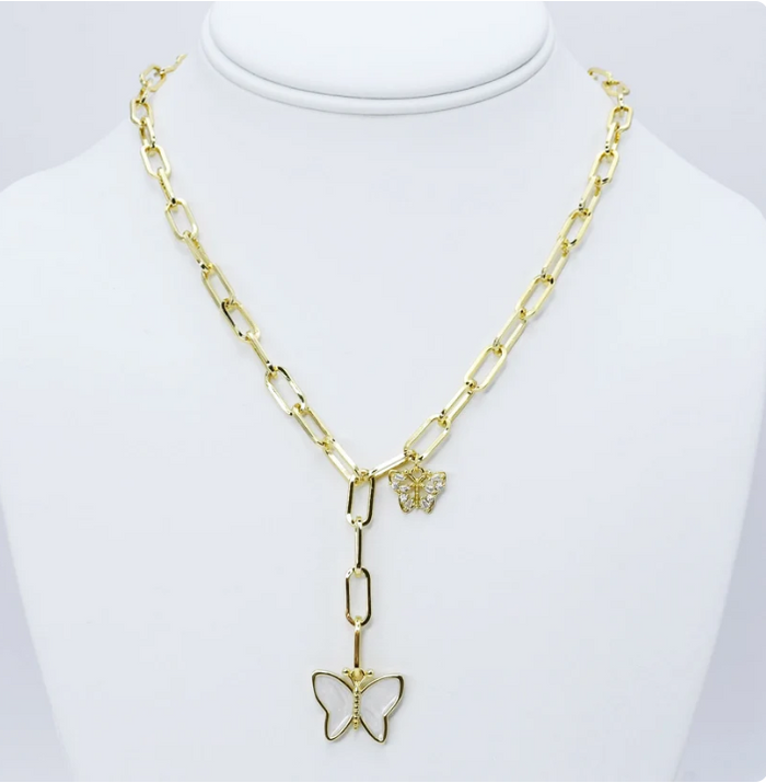 A gold-tone chain necklace displayed on a white mannequin bust. The necklace features a paperclip-style chain, a butterfly-shaped pendant with a small clear stone center, and a small butterfly charm near the clasp.