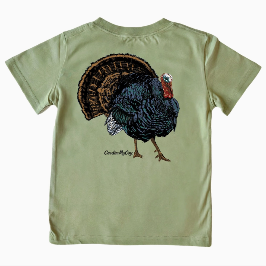 An olive green short-sleeve t-shirt shown from the back, featuring a large embroidered turkey graphic and the text 'Carter McCoy' printed below it.