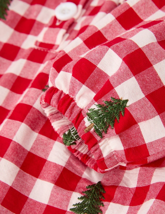 upclose of tree embroidery details on red and white dress holiday for little girls 