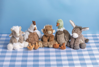 Set of plush toy animals on a blue checkered tablecloth