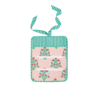 Small bag with floral design and green striped handle on a white background