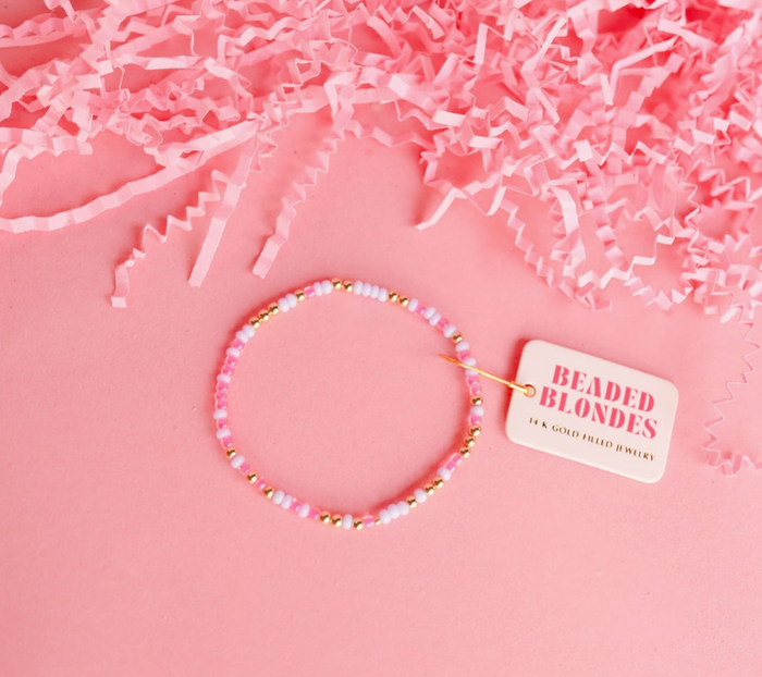 Beaded bracelet with a 'Beaded Blondes' tag on pink crinkled paper