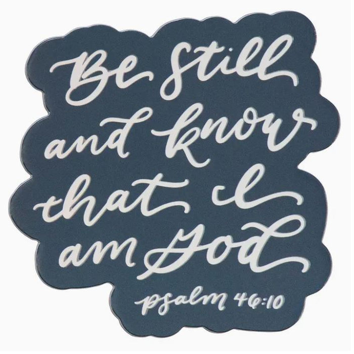 Decorative magnet with 'Be still and know that I am God' text on a dark blue background