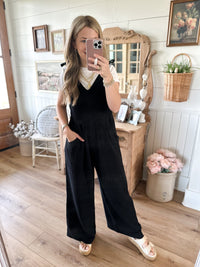 black cotton tie strap jumpsuit with pockets in front