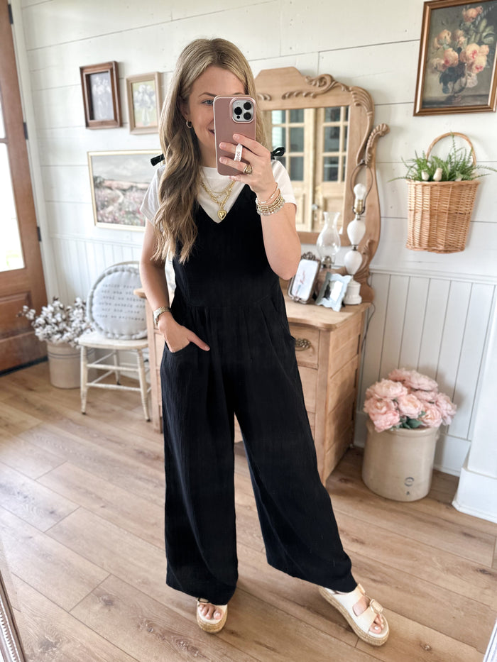 black cotton tie strap jumpsuit with pockets in front