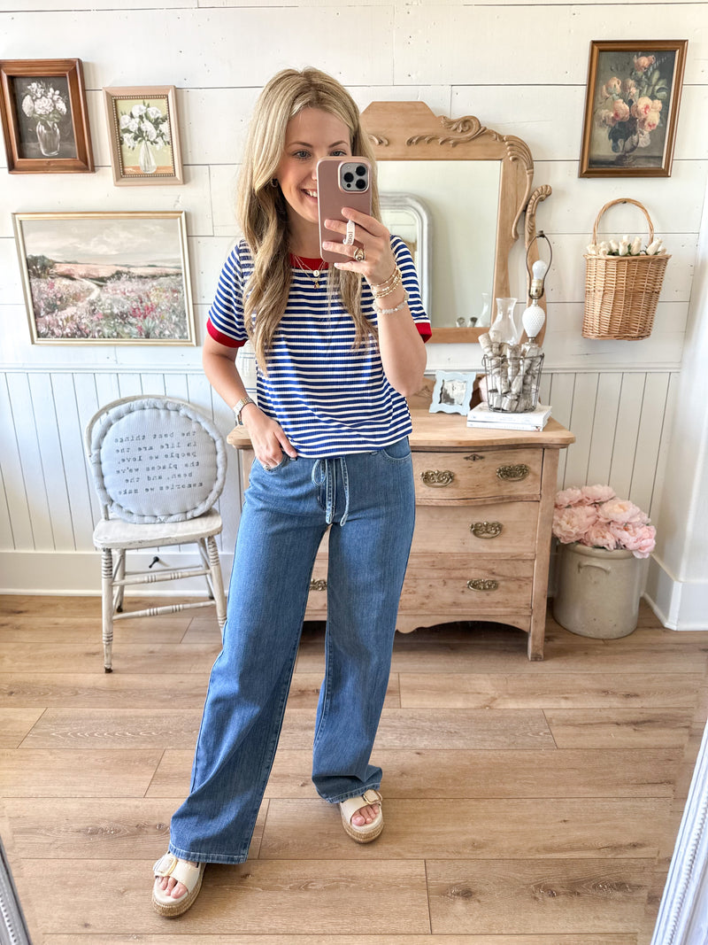 blue and white short sleeve top with accent of red staccato