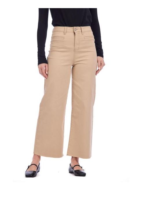 Person wearing light tan  pants and a black top on a white background mud pie tan jeans 