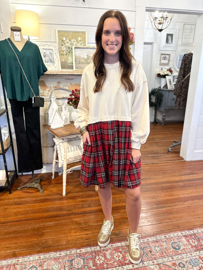 cream color sweater top of dress with red plaid at the bottom