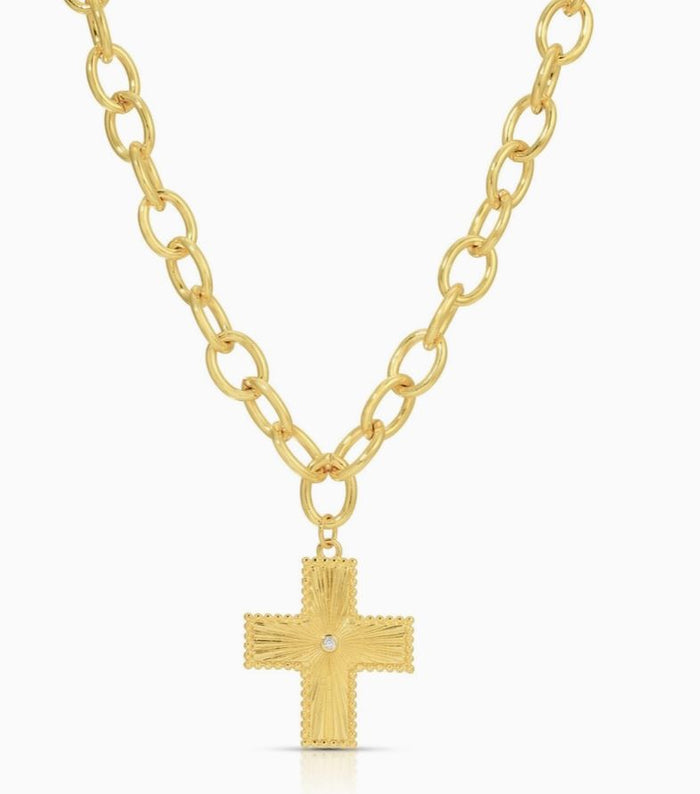 Gold chain necklace with a textured cross pendant on a white background